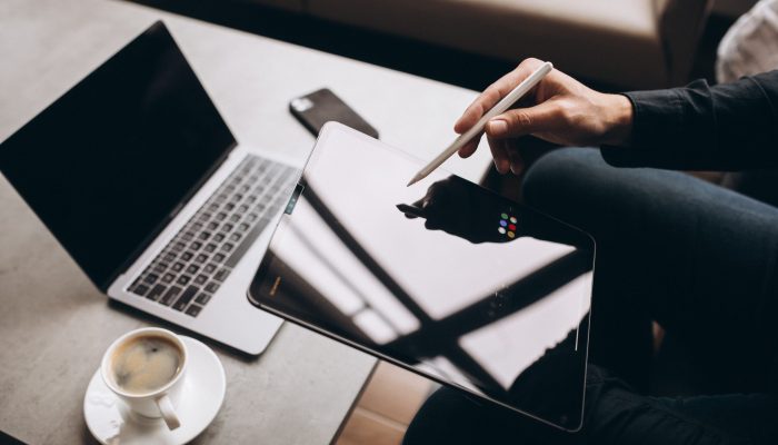Man working on tablet close up at the table